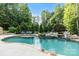 Beautiful outdoor pool and patio with comfortable lounge chairs and lush landscaping at 146 Bullfinch Rd, Mooresville, NC 28117