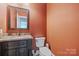 Stylish powder room with warm paint, granite counters and a vanity at 146 Bullfinch Rd, Mooresville, NC 28117