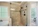 Tiled shower with glass door is a standout feature of this beautiful primary bathroom at 146 Bullfinch Rd, Mooresville, NC 28117