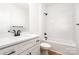 Bright bathroom featuring a vanity with a white countertop, white tile tub/shower, and a toilet at 150 Autumn Blaze Rd, China Grove, NC 28023