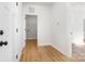 Hallway leading to laundry room showing light wood floors and white doors at 150 Autumn Blaze Rd, China Grove, NC 28023