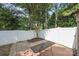 Secluded backyard with white privacy fence, shade trees, and patio area at 157 Talbert Town Loop, Mooresville, NC 28117