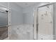 Bathroom featuring a soaking tub and walk-in shower with glass doors and silver hardware at 157 Talbert Town Loop, Mooresville, NC 28117