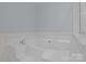 Close-up shot of a soaking tub with silver hardware and a tiled border at 157 Talbert Town Loop, Mooresville, NC 28117