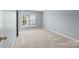 Empty bedroom with neutral carpet and large window at 157 Talbert Town Loop, Mooresville, NC 28117