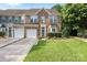 Beautiful brick townhome with well-manicured lawn, garage, and inviting front door at 157 Talbert Town Loop, Mooresville, NC 28117