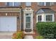 Charming townhome front entrance framed by brick and lush landscaping at 157 Talbert Town Loop, Mooresville, NC 28117