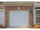 Attached one car garage door with a brick surround at 157 Talbert Town Loop, Mooresville, NC 28117