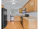 Functional kitchen featuring stainless steel appliances, wooden cabinetry, and hardwood floors at 157 Talbert Town Loop, Mooresville, NC 28117