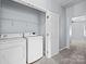 Laundry room with a washer, dryer, wire shelving, and a doorway leading to another room at 157 Talbert Town Loop, Mooresville, NC 28117
