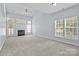 Bright living room with a fireplace, neutral walls, and large windows offering great natural light at 157 Talbert Town Loop, Mooresville, NC 28117