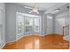 Sunlit room with wood floors, a ceiling fan and large windows at 157 Talbert Town Loop, Mooresville, NC 28117