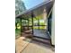 Inviting covered porch with steps leading to a well-maintained yard, ideal for entertaining and relaxing outdoors at 1678 Nelson Dr, Newton, NC 28658