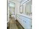 Bathroom with double sink vanity, white cabinets, and modern fixtures, across from an open bedroom at 1678 Nelson Dr, Newton, NC 28658