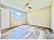 Bright bedroom featuring modern floors, ceiling fan, and a window at 1678 Nelson Dr, Newton, NC 28658