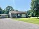Inviting home with a cozy front porch, carport and green lawn at 1678 Nelson Dr, Newton, NC 28658