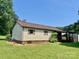 Exterior view of a well-maintained home featuring a covered porch and a spacious backyard with trees at 1678 Nelson Dr, Newton, NC 28658