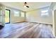 Living room featuring new flooring, fresh paint, a fan, and a door leading to the backyard at 1678 Nelson Dr, Newton, NC 28658
