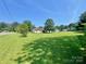 Expansive grassy lawn with mature trees surrounding this home at 1678 Nelson Dr, Newton, NC 28658