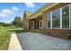 This house has a simple brick design with a large concrete patio and green grass at 170 Saint James Way, Salisbury, NC 28147