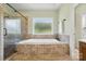Luxurious bathroom with a glass shower and a large soaking tub with a window at 170 Saint James Way, Salisbury, NC 28147