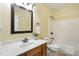 A functional bathroom with wooden cabinets, white marble countertop, and a shower-tub combo at 170 Saint James Way, Salisbury, NC 28147