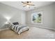 Bright bedroom with a striped bed, fan, and a large window with a pleasant outdoor view at 170 Saint James Way, Salisbury, NC 28147