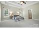 Spacious primary bedroom with neutral carpet, ceiling fan and two large windows at 170 Saint James Way, Salisbury, NC 28147