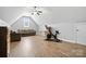 A recreational bonus room featuring hard-surface flooring, a stationary bike, and comfortable seating at 170 Saint James Way, Salisbury, NC 28147