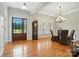 Elegant dining room featuring wood floors, chandelier, and natural light with backyard view at 170 Saint James Way, Salisbury, NC 28147