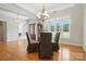 Open-concept dining area boasting hardwood floors, large windows, and a stylish chandelier at 170 Saint James Way, Salisbury, NC 28147