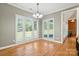 Sun-filled dining room features hardwood floors, chair rail, and multiple large windows at 170 Saint James Way, Salisbury, NC 28147