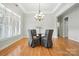 Cozy dining area with wood floors, modern chandelier and window view at 170 Saint James Way, Salisbury, NC 28147