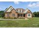Charming brick home with dormers, bay window, covered porch, and manicured lawn at 170 Saint James Way, Salisbury, NC 28147