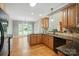 Kitchen with wooden cabinets, granite counters and stainless steel appliances including a view to the backyard at 170 Saint James Way, Salisbury, NC 28147