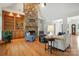 Cozy living room with a stone fireplace, built-in shelves, and hardwood flooring at 170 Saint James Way, Salisbury, NC 28147