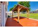 Backyard space features a deck with wooden pergola, green grass and full fencing for privacy at 1706 Baylor Dr, Rock Hill, SC 29732
