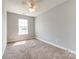 Empty bedroom with carpet flooring, ceiling fan, and a bright window at 1706 Baylor Dr, Rock Hill, SC 29732