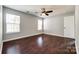 Empty bedroom showcasing hardwood floors, neutral walls, and natural light from two windows at 1706 Baylor Dr, Rock Hill, SC 29732