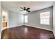 Spacious bedroom with hardwood floors, ceiling fan, and ample natural light from two windows at 1706 Baylor Dr, Rock Hill, SC 29732