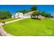 Charming home with lush front yard, mature trees, and a long driveway leading to an attached garage at 1706 Baylor Dr, Rock Hill, SC 29732