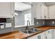 Close-up of kitchen sink, wood countertops, and modern fixtures at 1706 Baylor Dr, Rock Hill, SC 29732