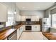 Bright kitchen with stainless steel appliances, tile floors, wood countertops, and white cabinetry at 1706 Baylor Dr, Rock Hill, SC 29732