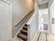 Carpeted staircase featuring a white handrail at 1706 Baylor Dr, Rock Hill, SC 29732