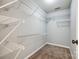 Walk-in closet with carpet flooring and ample shelving for organized storage at 1706 Baylor Dr, Rock Hill, SC 29732