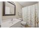 Clean bathroom with a white vanity, floral shower curtain, and neutral walls at 1921 Williford Woods Ln, Rock Hill, SC 29730