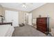 Spacious bedroom with carpet, white trim, and a large dresser at 1921 Williford Woods Ln, Rock Hill, SC 29730