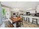 Open concept kitchen with dining area, modern appliances, and breakfast bar with seating at 1921 Williford Woods Ln, Rock Hill, SC 29730