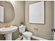 Elegant powder room featuring a pedestal sink, round mirror, and stylish decor at 2005 Waxhaw Crossing Dr # 241, Waxhaw, NC 28173