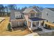 Beautiful brick two-story home with a covered front porch and a well-maintained front yard at 2005 Waxhaw Crossing Dr # 241, Waxhaw, NC 28173